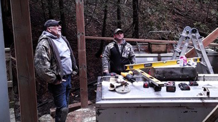 Two People Constructing a Hut